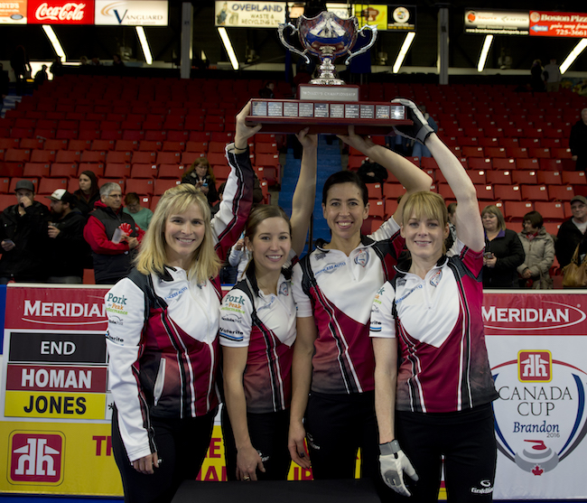 (L to R) Jennifer Jones, Kaitlyn Lawes, Jill Officer and Dawn McEwen hoist the Canada Cup. (Michael Burns/Curling Canada)