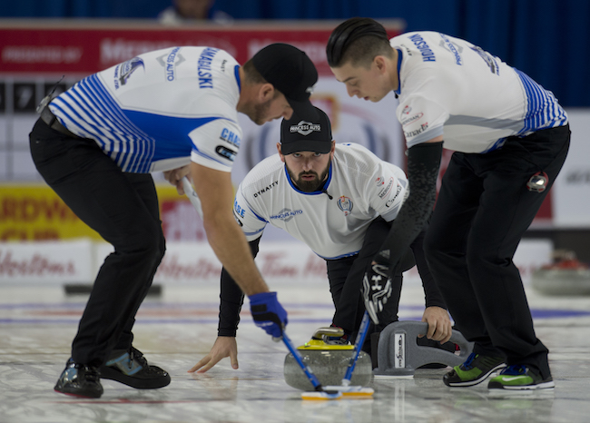 Skip Reid Carruthers watches as sweepers Derek Samagalski (L) and Colin Hodgson guide a rock during the men's final at the 2016 Canada Cup. (Michael Burns/Curling Canada)